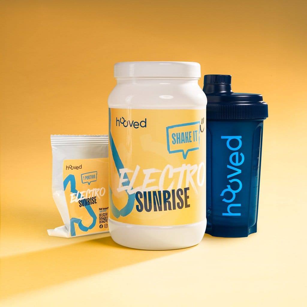 Weiße Dose und Packung mit blauer und gelber Verpackung, beides mit "Electro Sunrise" und "Shake It" Beschriftung, blaue Flasche gegen den gelben Hintergrund.